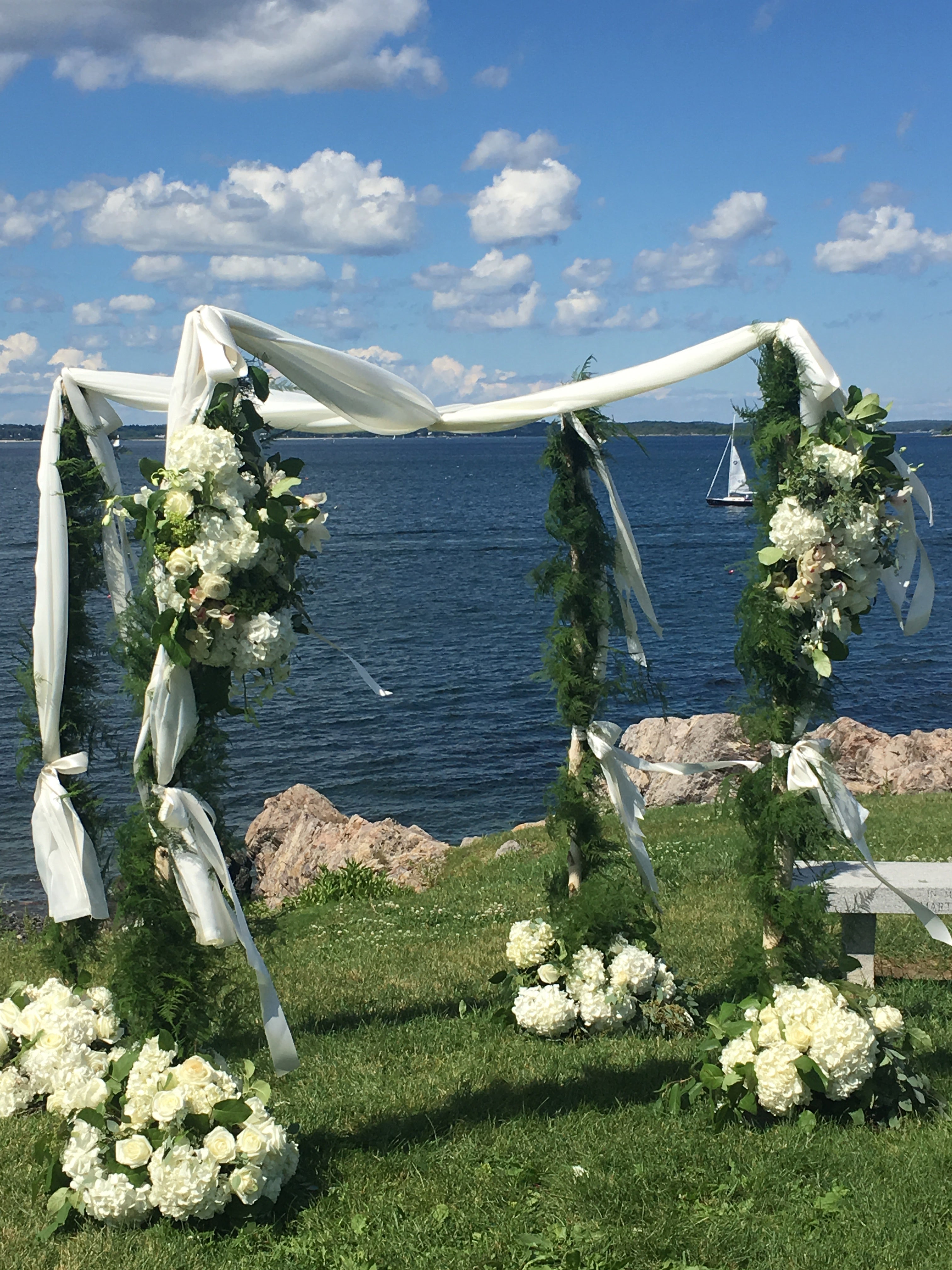 Seaside Chuppah with Large White Bouquets and Garland