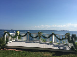 Outdoor Wedding Balcony with Garland and Bouquets overlooking the Ocean